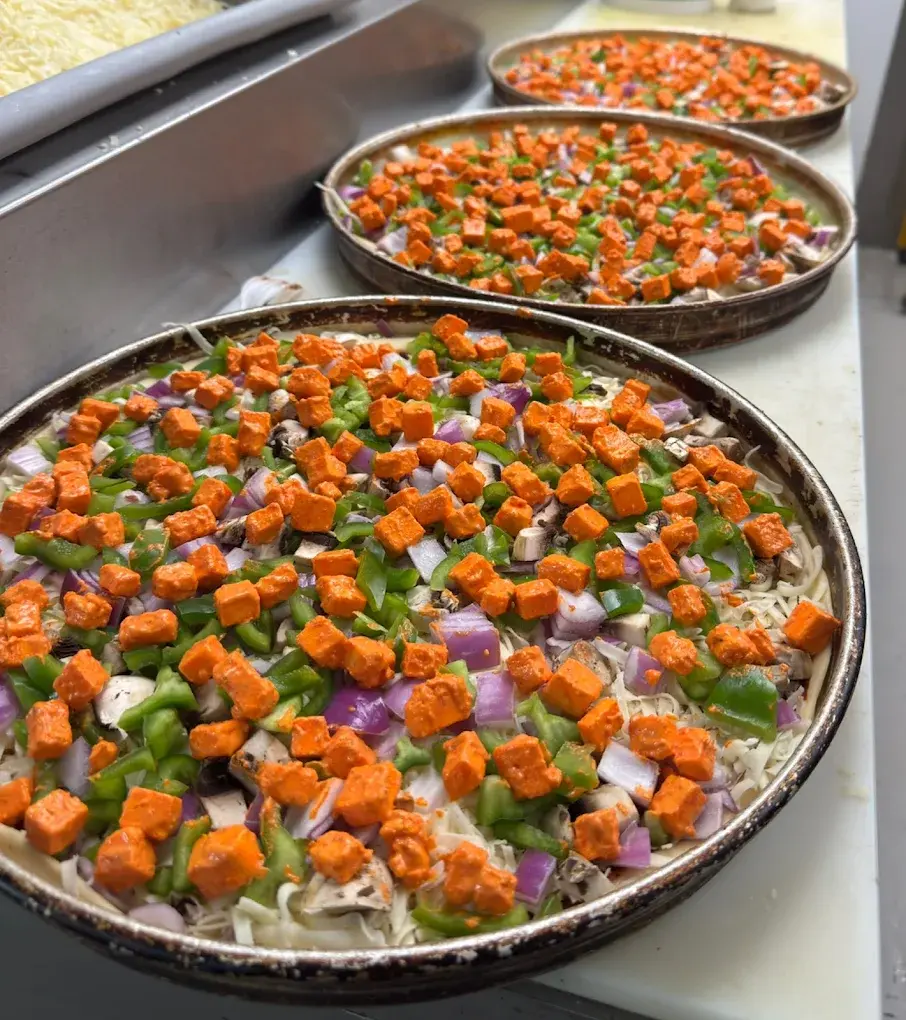 Supreme Pizza Edmonton franchise opportunity - Italian-Indian fusion pizza brand storefront and signature pizzas